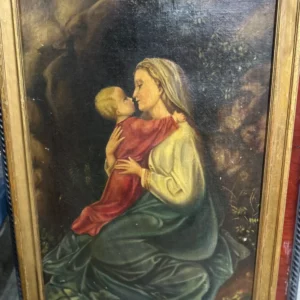 Framed devotional-style portrait of a seated woman in red and gold garments looking upward.