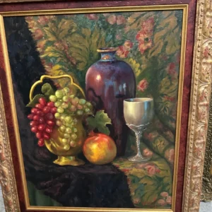 Richly colored still life featuring grapes, fruit, a wine glass, and a decorative vessel.