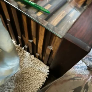 Geometric wood and glass console table with colorful art and collectibles on display