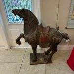 Large decorative sculpture of a rearing horse with a dark antiqued finish, mounted on a rectangular base.