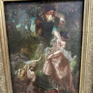 Framed romantic scene of an elegantly dressed couple in a wooded garden, presented in an ornate light-toned frame.