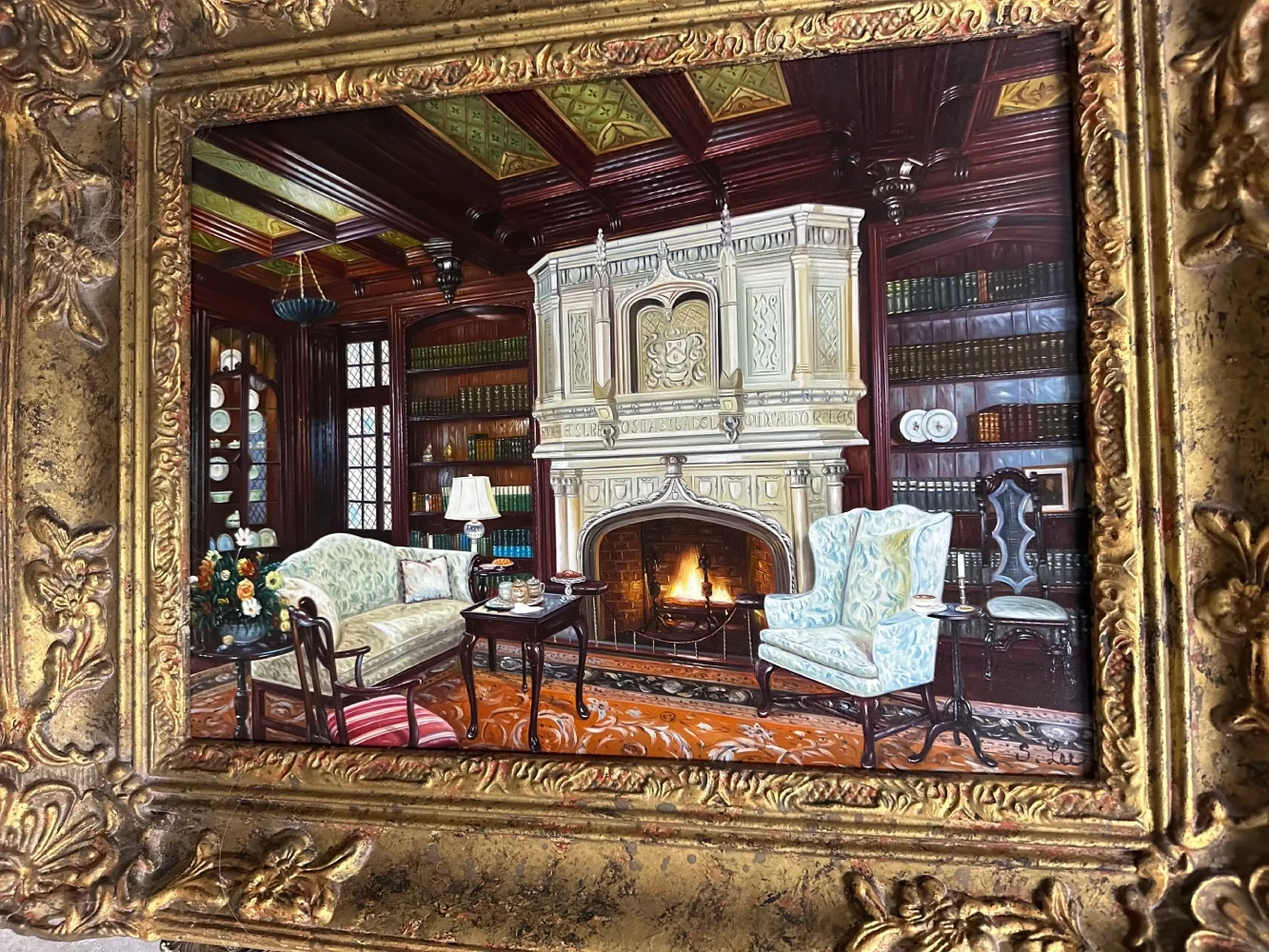 Ornately framed interior scene of a wood-paneled lodge with a stone fireplace and upholstered seating.