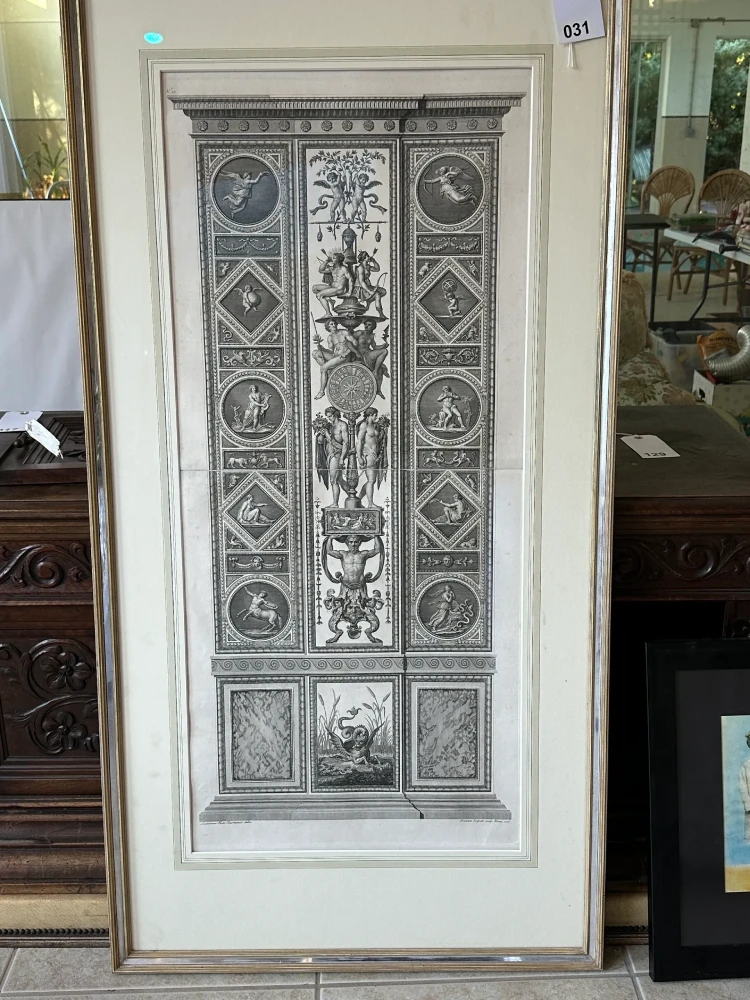 Tall framed monochrome artwork featuring an intricately detailed classical doorway and architectural motifs.