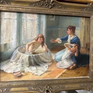 Ornately framed interior scene of two women in Victorian dress seated in conversation by a window.